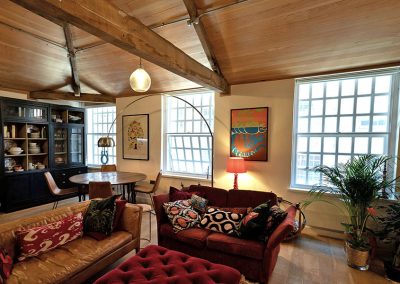 Loft-style apartment with high ceilings, comfy sofas and three windows with Granada Secondary Glazing Units installed