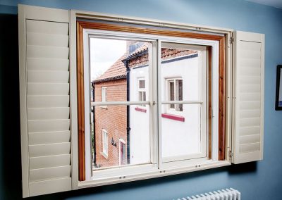 Modern room with cottage-style casement windows with mid-rail fitted with sliding Granada secondary glazing units